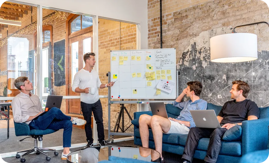 Team reviewing a whiteboard of sticky notes during a sprint planning session
