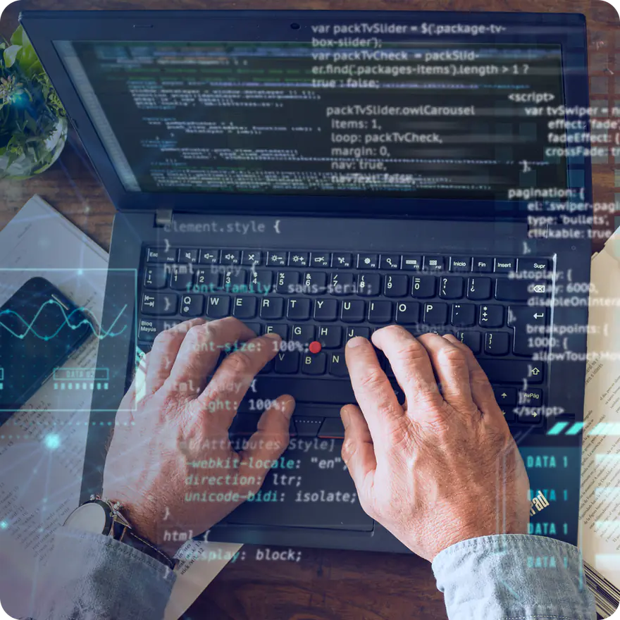 Software developer writing code on a laptop